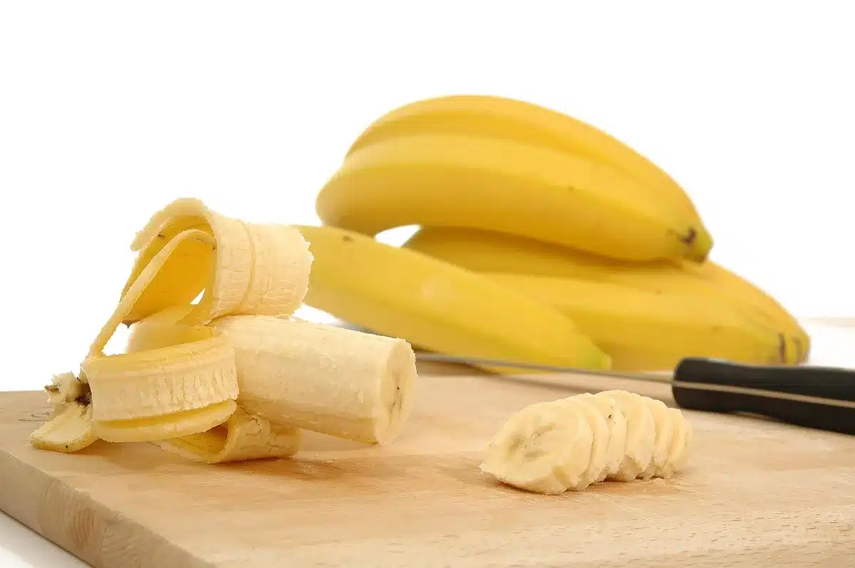 Bol de yaourt avec banane tranchée et poignée d'oléagineux